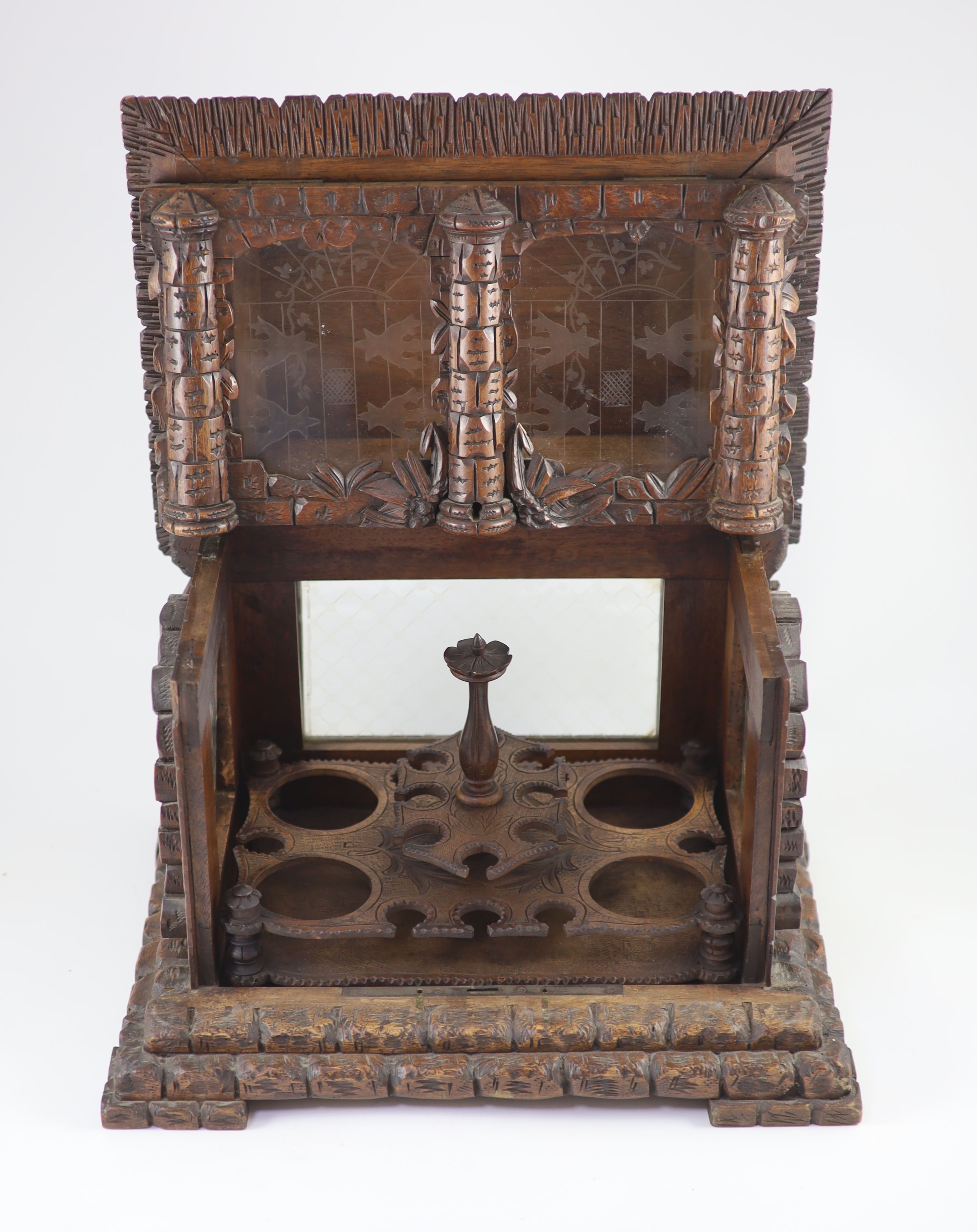 A late 19th century Black Forest carved wood liqueur casket width 44cm depth 32cm height 41cm